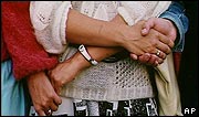Women hold hands in the human chain linking Baltic states
