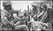 Israeli soldiers guard a prisoner 