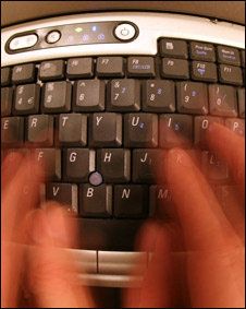 Hands typing on a computer keyboard