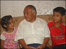 Abdumavlon Mirzoahmedov and his grandchildren, Hulkar and Farrukh