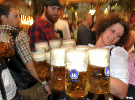 A waitress carries glasses of beer at the Oktoberfest in Munich, southern Germany.