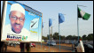A woman walks past a billboard featuring presidential candidate of Congress for Progressive Change (CPC) Muhammadu Buhari in Kaduna Tuesday, March 1, 2011. 