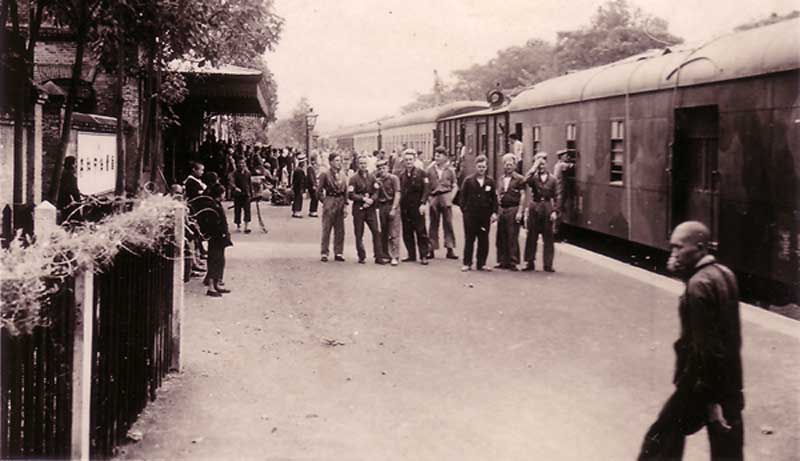 Crew of HMS Capetown waiting to catch the train to Hong Kong