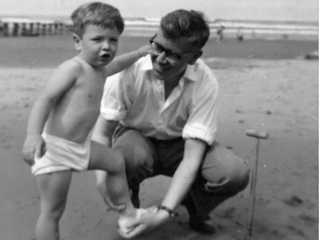 Matthew Bannister on the beach with his father