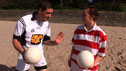 Conall Ó Máirtín demo’s tackling to young ladies' footballer on the beach.