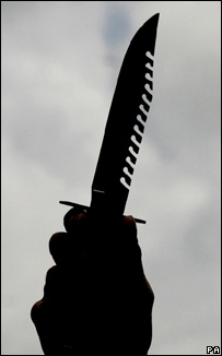 police officer holding a knife handed in during an amnesty Andrew Milligan/PA Wire