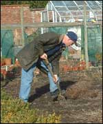 One of the gardeners digging 