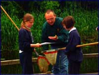 Image of a fisherman instructing pupils