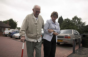 A deafblind man with his red and white cane