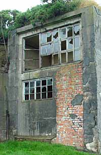 Why would a backup generator station need large picture windows looking out to sea?