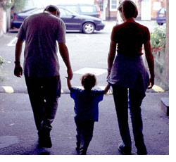 Image: Child holding parents' hands