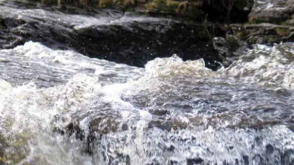 Close up of water flowing over Falls of Dochart