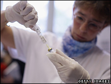 A nurse prepares a dose rate of H1N1 swine flu vaccination