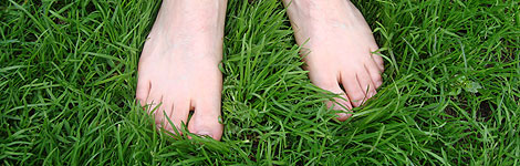 Feet standing on grass