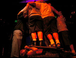 The Torture King lying on bed of nails with 4 people standing on him (copyright Jon Alloway)