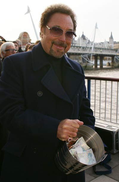 Tom Jones with the money he raised for charity from the Busking challenge