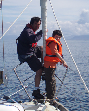 Father and son on the bow of a yacht