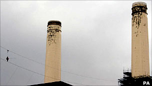 High-wire walker and power station chimneys