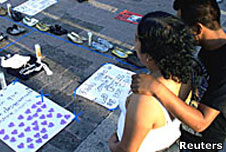 Residents look at shoes of missing people