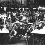 Peter Oakley at the front of a VJ Party in the Swan Yard, Whitwell.