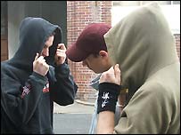 Youths wearing hoods and baseball caps