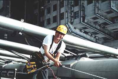 Worker hangs from the side of the building