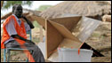 Sudanese electoral officials wait next to empty ballot boxes for the arrival of new voting material after what they had received earlier turned out to belong to another voting centre in the south Sudan capital of Juba 