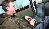 Pete on his lap top in the car