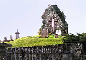 The original gable wall of the old church is the place where St. Aidan is buried.