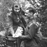 Doris is helped over a style by her fiance, Len (Royal Artillery) 1942, Meldreth in Cambridgeshire