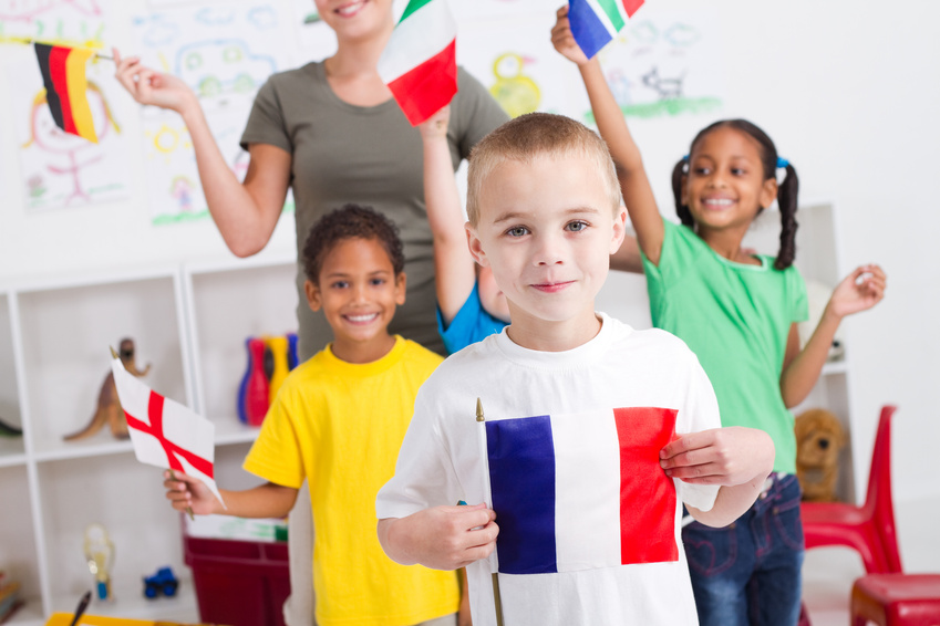 Happy little French boy with various classmates in background @ michaeljung - Fotolia.com