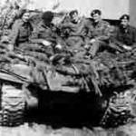 Denis (centre), Tom (far right), and Bert (between them), on top of their Sherman. This picture was taken in Bremen in April 1945. (Eric Hoskins is on the left, next to him is Capt J (Wally) Arseneault - see his story at A2730214 "A Welcome Find in Hamburg").