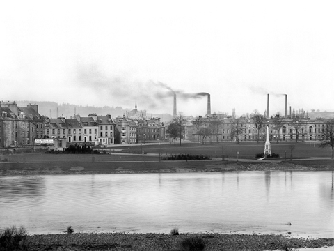 Black and white view from Moncrieff Island showing the North Inch, with smoking industrial chimney stacks behind.