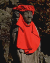 Statue in a shrine decorated with a bright red garment