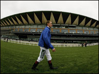 Jockey Martin Dwyer passes the new grandstand at Ascot Racecourse on May 27, 2006, in Ascot.