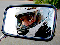 View of Chris in his motorbike's mirror