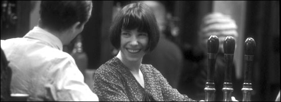 A man and woman talking in a British pub