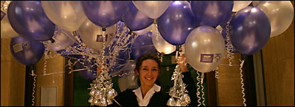 World Service employee holding balloons