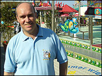 BBC Radio Manchester reporter Ian Cheeseman in front of a funfair ride in Hamburg