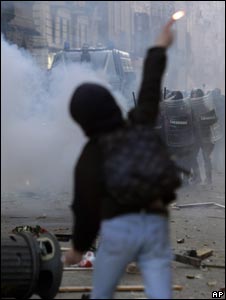 Demonstrator hurls a flare in Rome (14 Dec 2010)