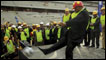 President Zuma of South Africa kicks a ball during a visit to a stadium construction site