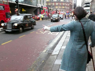 Kate tries her luck hailing a black cab