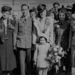 From left to right - Mrs Elizabeth Hitchings, Mr William Hitchings, Mrs Beatrice Maud Monks, Mr William Hitchings, Flight Sgt John A Monks (groom), Miss Ann Monks, Miss Gwen Hitchings (bride), Mrs Evelyn Moore, Gunner Partridge, Miss Betty Hitchings, Mr Fred Smith, Mrs Doreen Rowlands (nee Hitchings) and Mr Norman Hitchings. In front - Miss Rosemary Mendus.