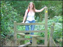 Web producer Faye climbing a stile