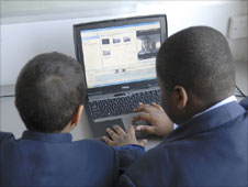 two schoolboys using a laptop