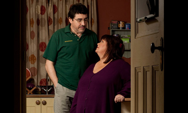 Roger and Val standing together in the kitchen