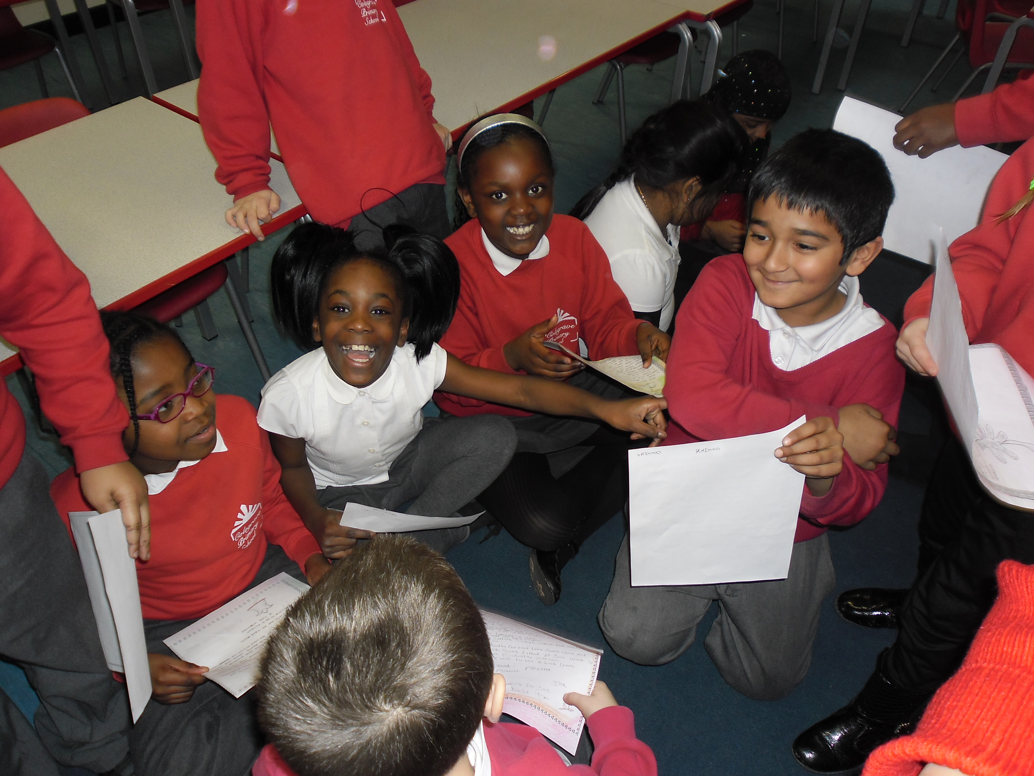 Pictures pupils reading letters for their partner school in Ethiopia