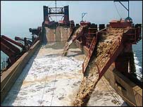 Gravel is sorted through a bed on board the vessel