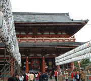 Red-and-white painted shrine building with traditional Japanese curved roof