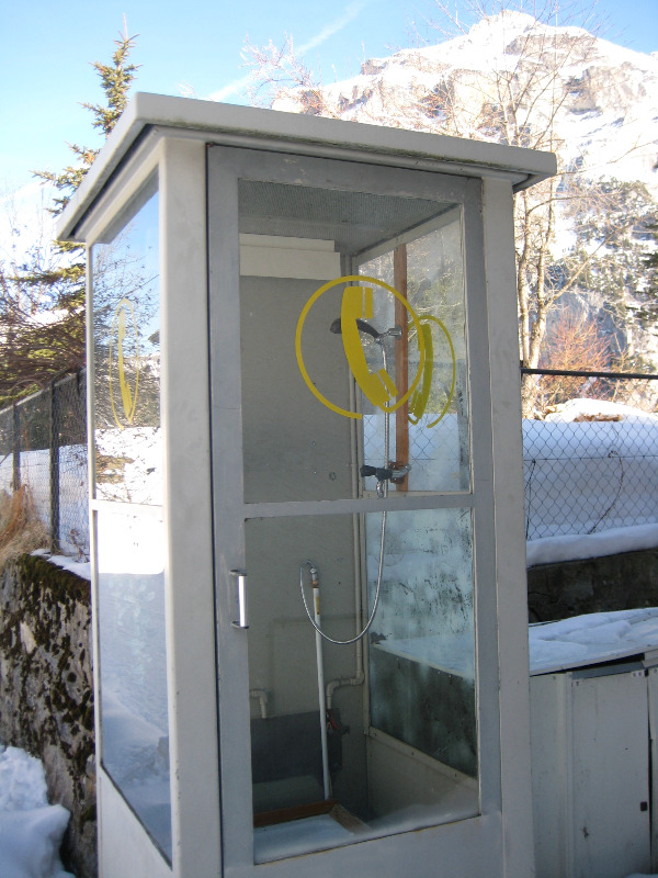 Telephone box coverted into a shower in the Swiss Alps.